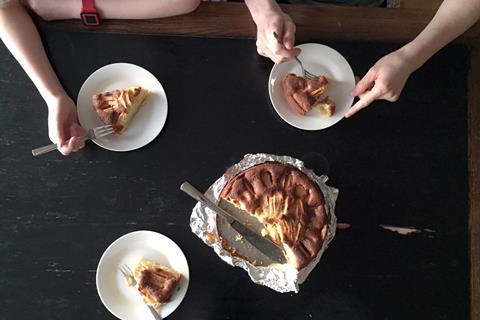 A photo of two women sharing some homemade cake