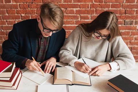 One male, one female student, studying together