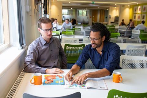 An image showing two teachers reading and discussing a Chemistry World article; the July issue of the Education in Chemistry magazine can be seen on the table