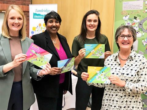 Pfizer team holding science in a box pamphlets