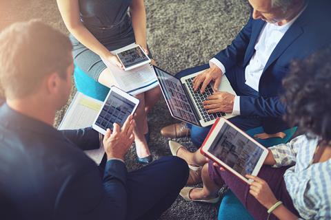 People meeting and using laptops, tables and mobile phones