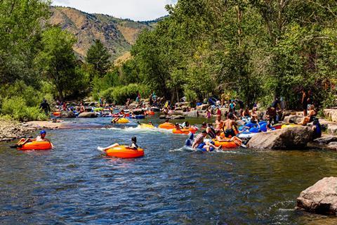 People enjoying a sunny day in a river in a valley