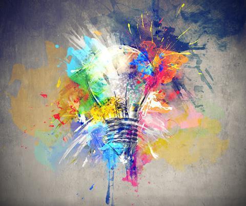 A light bulb with brightly coloured paint splashed on