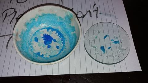 One large bowl with blue copper sulfate crystals, one watch-glass with smaller crystals