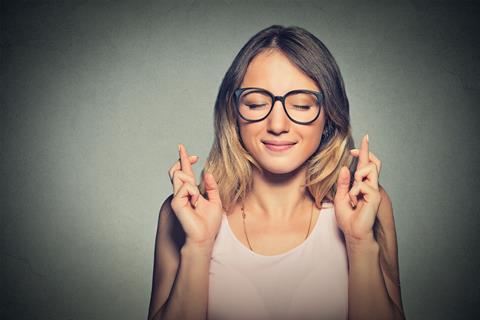 Woman crossing her fingers for a good exam result