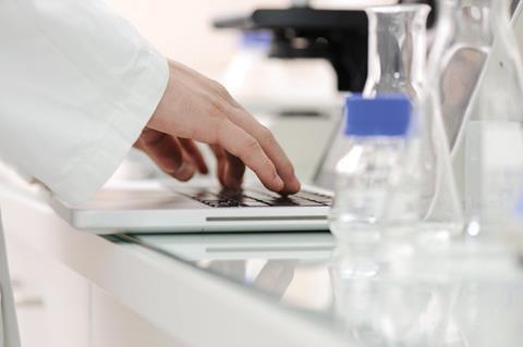 Scientist using a laptop comptuer in a laboratory