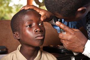 Medical personnel screen students in Togo for signs of river blindness
