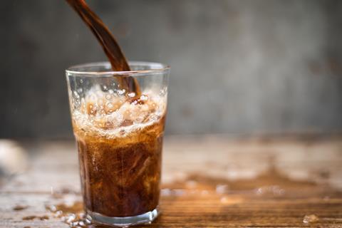 Pouring a fizzing and bubbling glass of cola