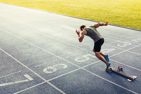 Man sprinting out of the blocks on a track