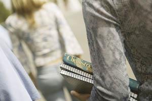 Student carrying a chemistry textbook