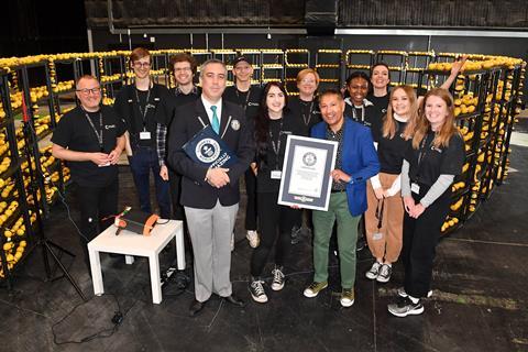 A group of people with a certificate and lots of lemons and wires