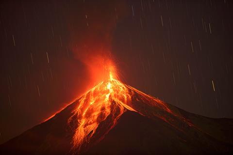 Volcano erupting red hot lava