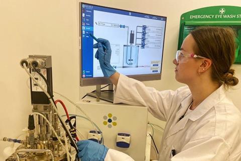 Emma working at a computer in the laboratory.