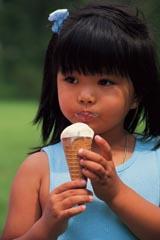 A child eating a vanilla ice cream