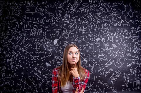 A teacher looking throughtful surrounded by science symbols