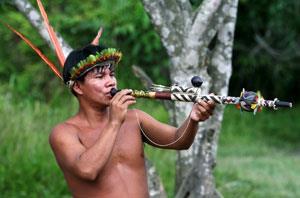 A South American Indian using a blowpipe