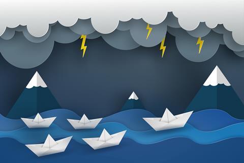 A graphic image showing white paper boats on a blue sea during a storm, with grey clouds and lightning bolts
