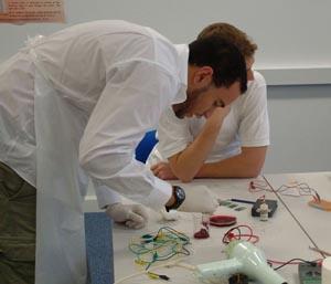 A teacher supporting a student in creating a circuit