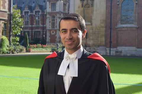 A photo of a man in graduation robes