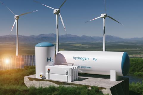 A digital illustration of wind turbines, solar panels and hydrogen production