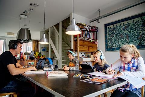 An image showing a father and children working from home during coronavirus