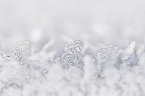 A close-up photograph of ice crystals in frost