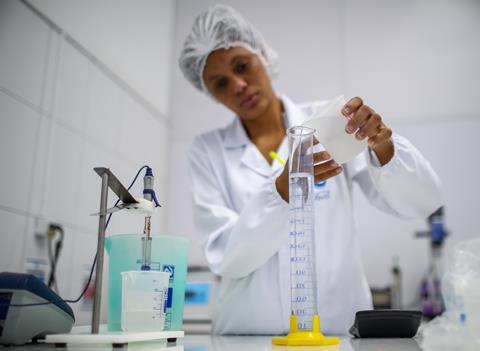 An image showing a technician making hand sanitiser