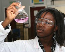 Female scientist holing a glass flask