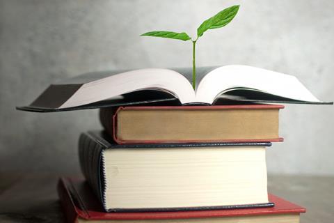 A plant sprouting from the pages of a book