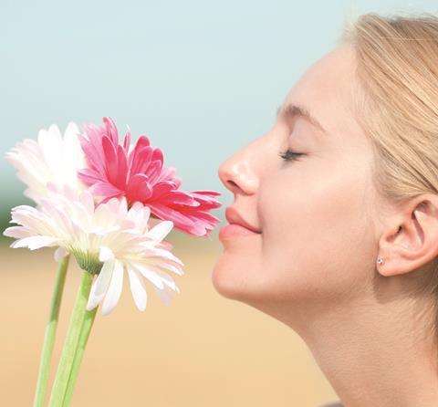 female smelling flowers