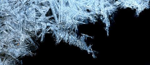 Ice crystals forming with a black background, right-hand corner
