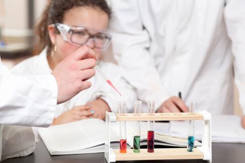 A photo of students doing an experiment in a school lab