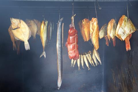 A range of foods hanging in a smokehouse