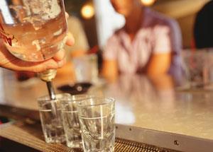 Pouring out a measure of alcohol into a shot glass