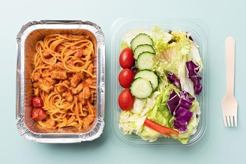 Spaghetti in an aluminium takeaway container and salad in a polyethylene container