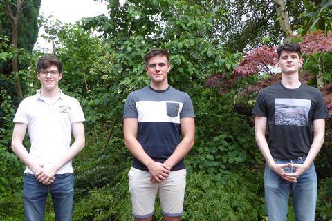Photo of three male students with green background