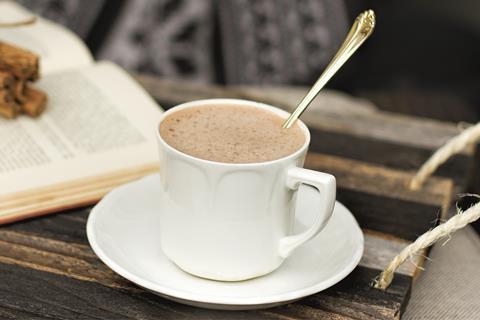 A spoon in a white mug of hot chocolate