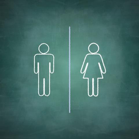 Male and female stick figures on a chalk board