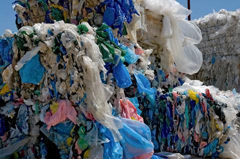 A photo of baled waste plastic bags for recycling
