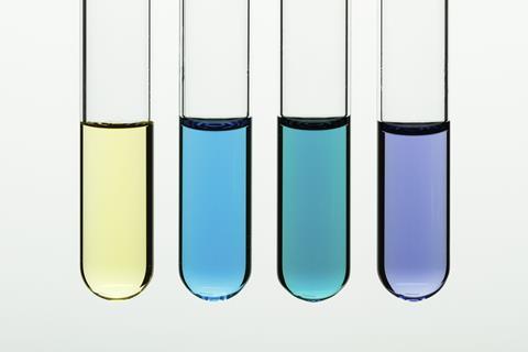 Four test tubes in a row different coloured liquids