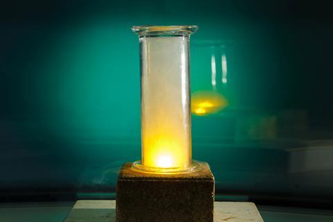 A yellow glow in a glass jar in a lab