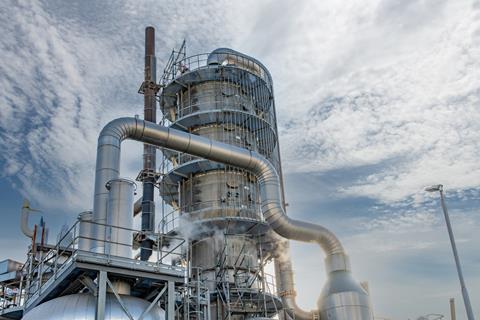 A fractional distillation tower with metal pipes an steam