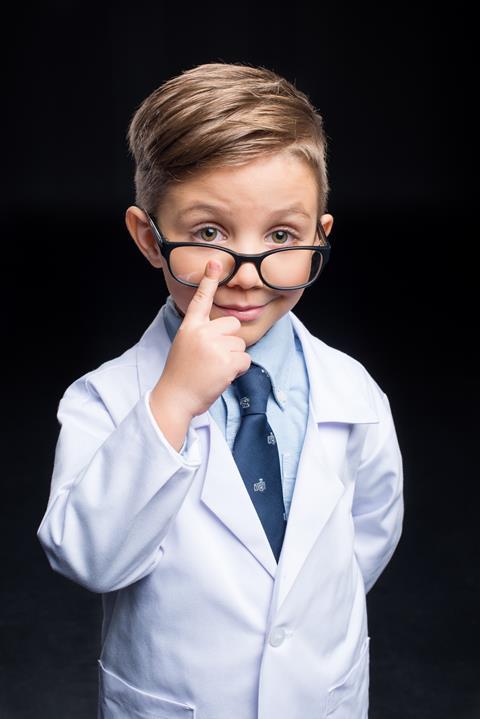 Young boy with a lab coat and glasses