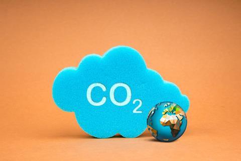 A sponge with CO2 written on next to a toy Earth