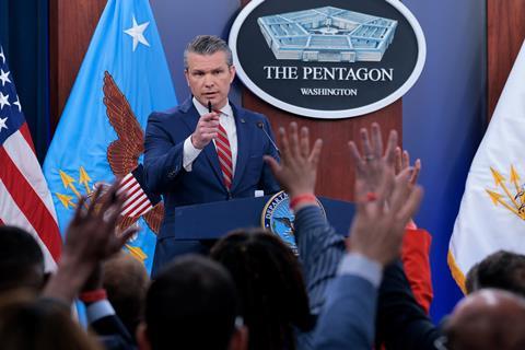 U.S. Secretary of War Pete Hegseth calls on reporters who have their hands raised with questions during a press briefing at the Pentagon