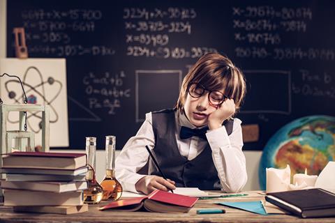 Child at school desk falling asleep