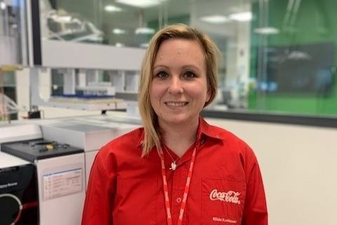 Hilde Kneblewski in a laboratory smiling at the camera.