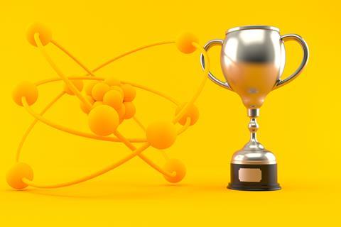 A digital artwork showing an atom next to a trophy