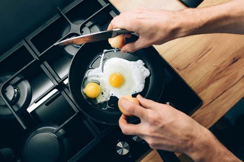 Someone frying eggs in a non-stick frying pan