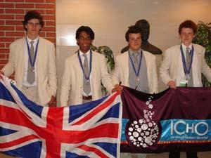 This year's successful Olympiad medallists holding a UK flag